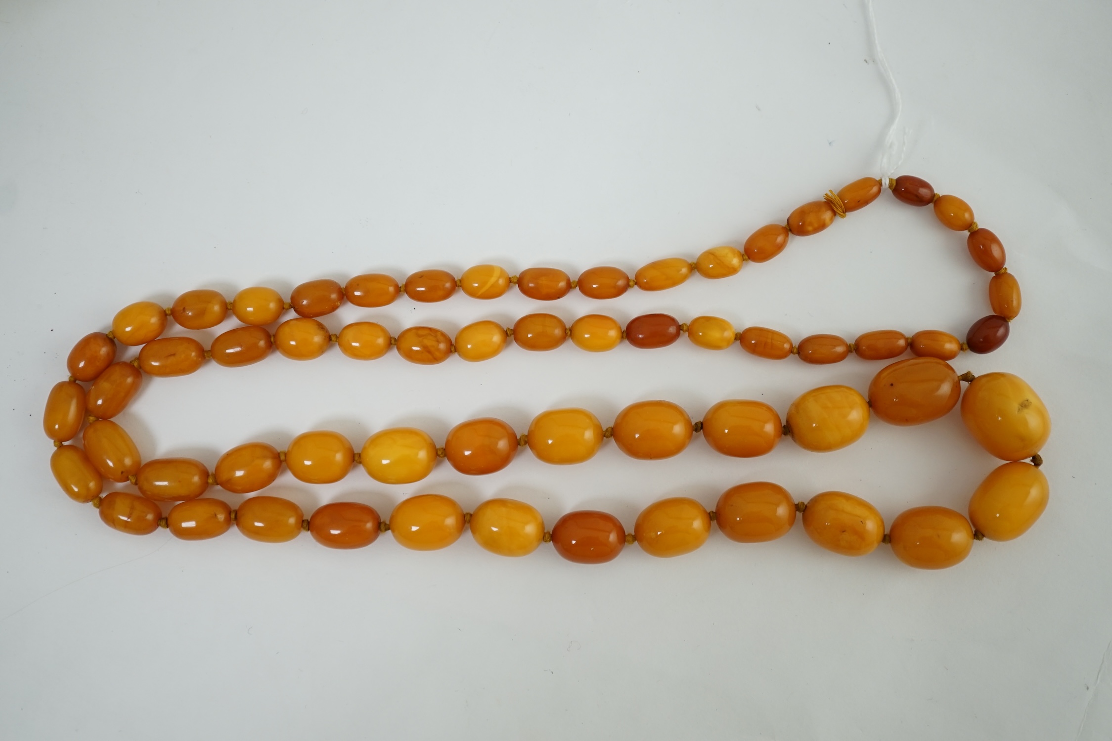 A single strand graduated oval amber bead necklace